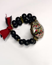 Load and play video in Gallery viewer, Hand Painted Jewelry Floral Mandala Pattern on Large Oval Stone with Black Beads and Gold Rectangular Beads with Red Tassels - #0066
