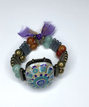 Load and play video in Gallery viewer, Hand Painted Mandala Large Oval Stone with Rectangular Band Bracelet with Purple Tassels - #0064
