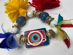 Double Sided Bracelet - 1) Red/White/Blue Evil Eye 2) This too shall pass in Farsi - Blue White silver Beads - Yellow and Red Tassels - Blue Ribbon - #0094